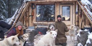 Owners/guides in front of their handmade guest cabin.